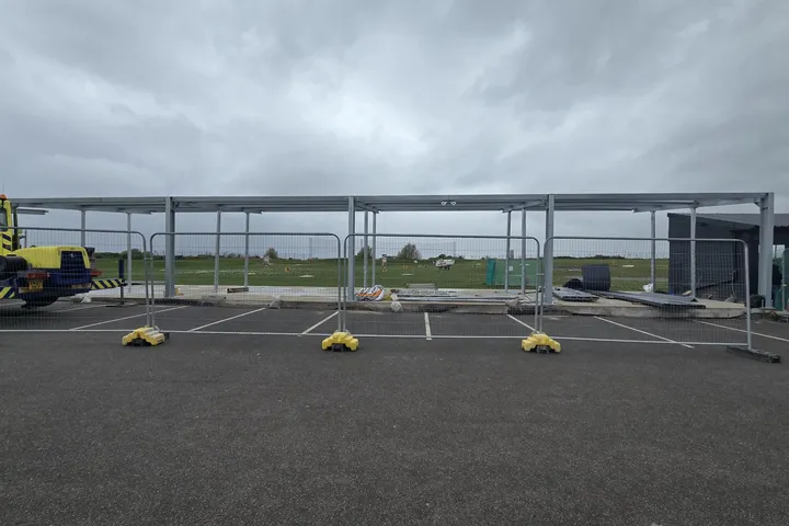 Completed steel canopy frame spanning the driving-range bays at Moreton Hills Golf Centre