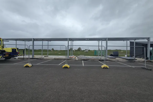 Completed steel canopy frame spanning the driving-range bays at Moreton Hills Golf Centre