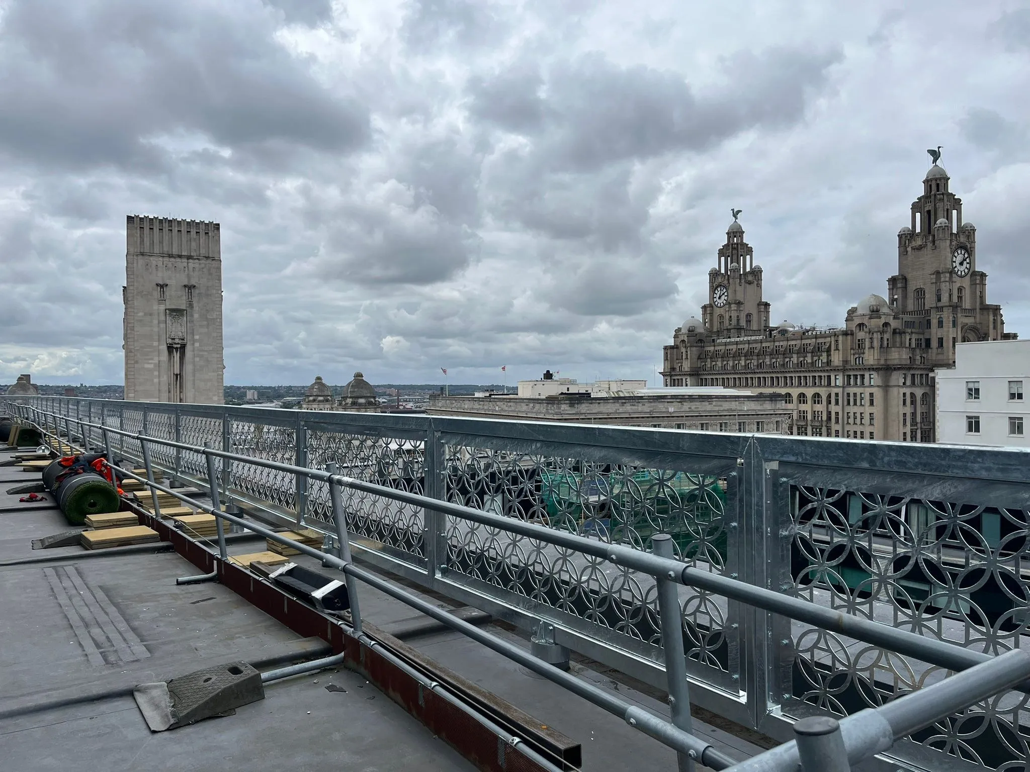 Rooftop balustrade run fabricated by MSR, with the Royal Liver Building and Liverpool waterfront behind