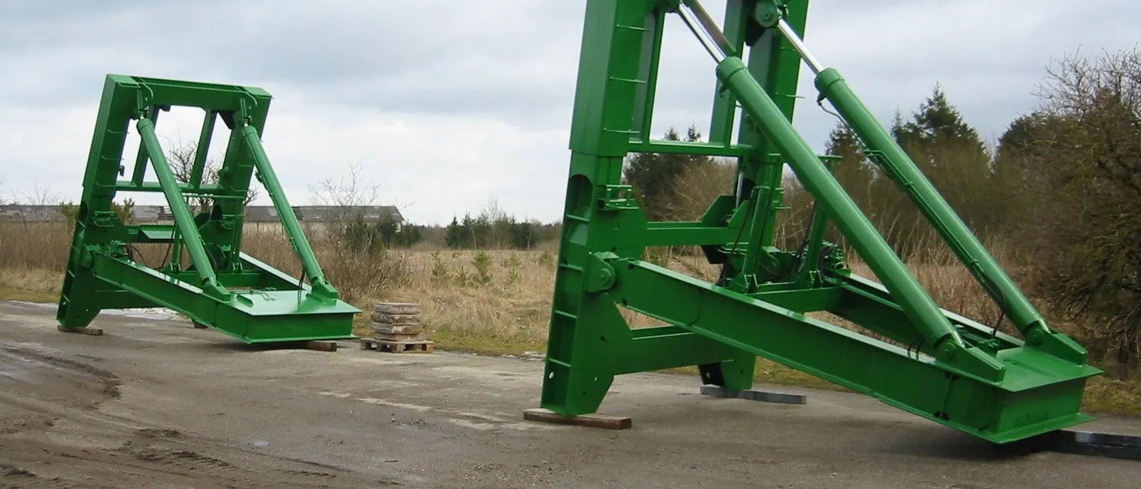 Fabricated structural steel gantry frames finished in green, ready for site delivery from MSR's Bootle works